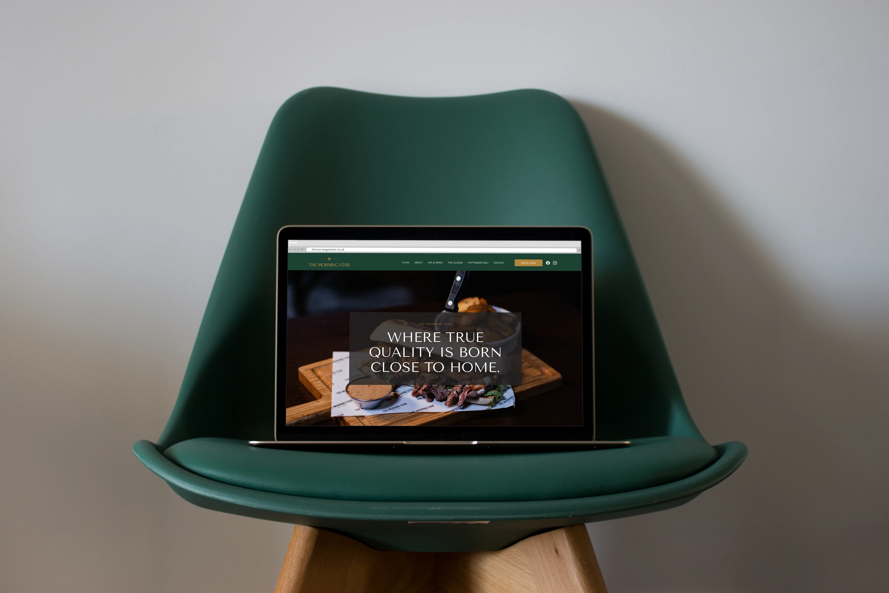 Open laptop on a green chair displaying a gastro pub website design, designed by Dream Wild Studio