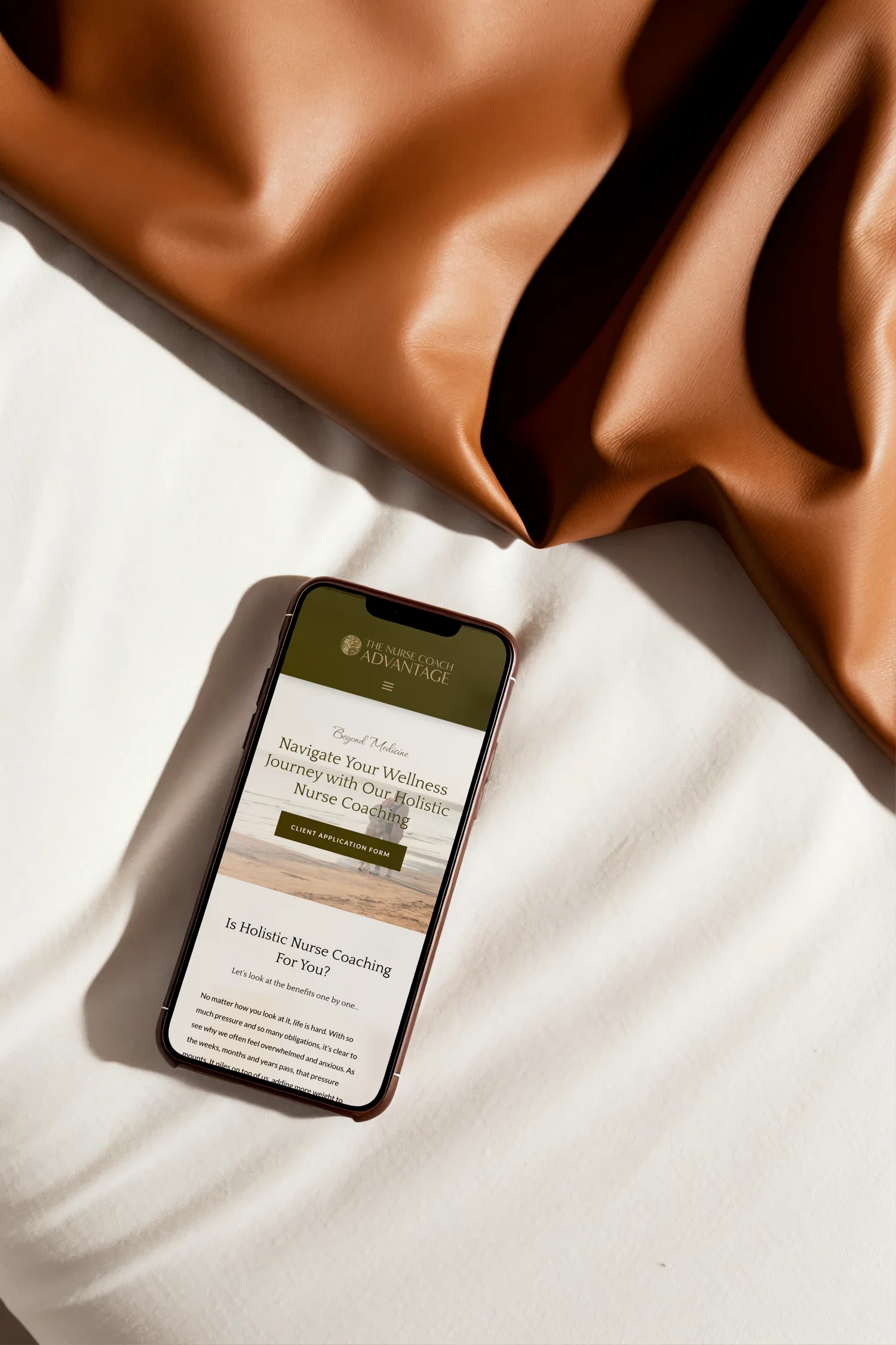 A phone is displaying a website for a nurse coach, and wellness business. Website design by Dream Wild Studio.