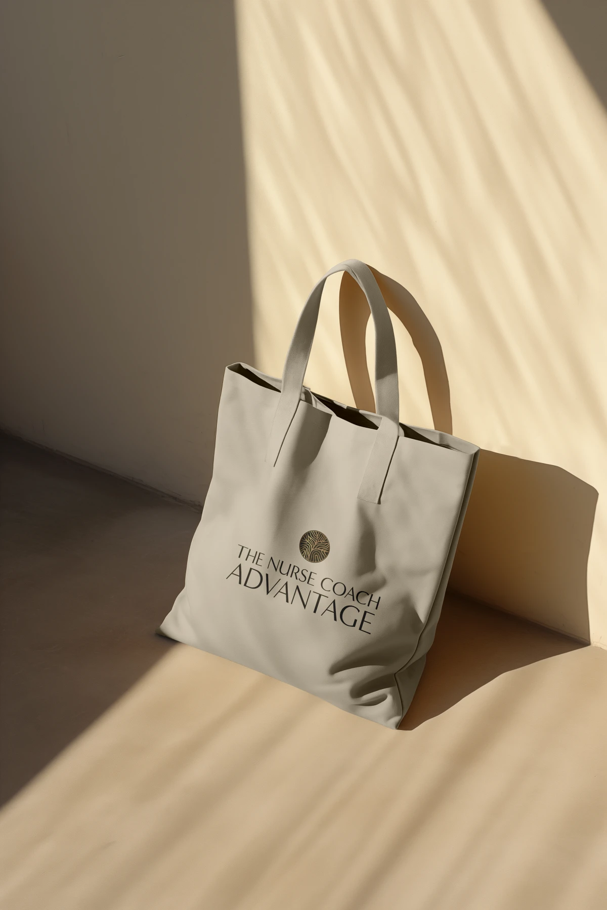 Eco-friendly tote bag featuring the logo for a nurse coach and their holistic coaching business, placed against the wall. Designed by Dream Wild Studio.