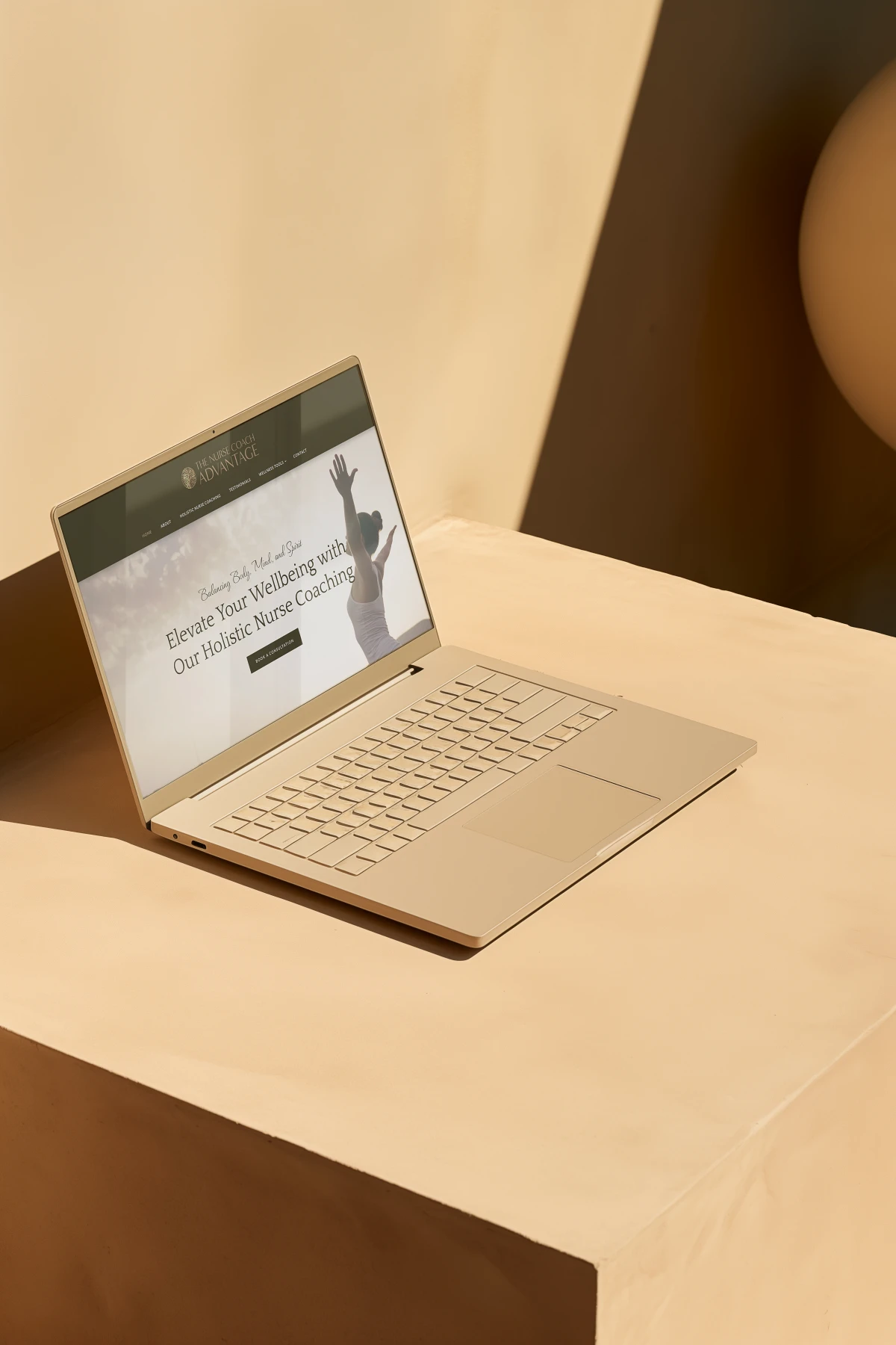 Open laptop on the table display website for nurse coach and their holistic coaching business. Website design by Dream Wild Studio.