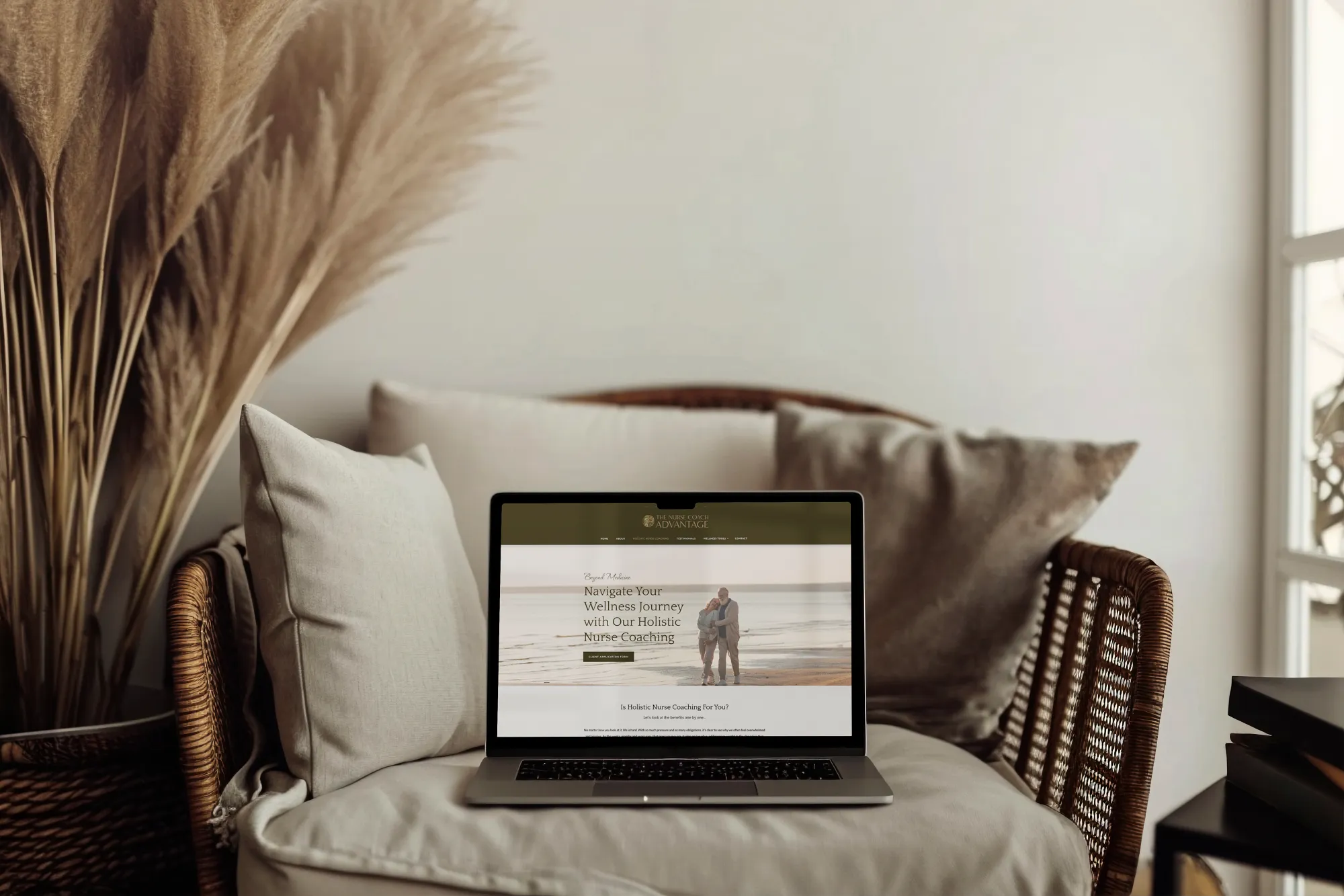 Nurse coaching website homepage displayed on a laptop in a styled interior setting. Designed by Dream Wild Studio.