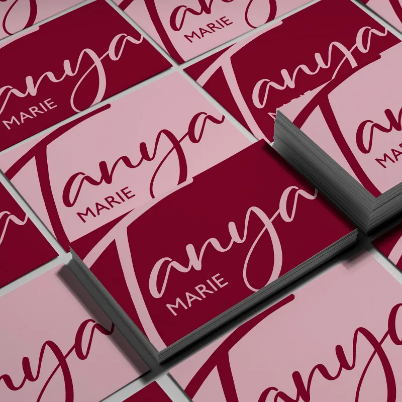Bold and stylish logo design on a business card, featuring a deep red and pink color scheme with elegant script typography. Branding created by Dream Wild Studio. Bold and stylish logo design on a business card, featuring a deep red and pink color scheme with elegant script typography. Branding created by Dream Wild Studio.