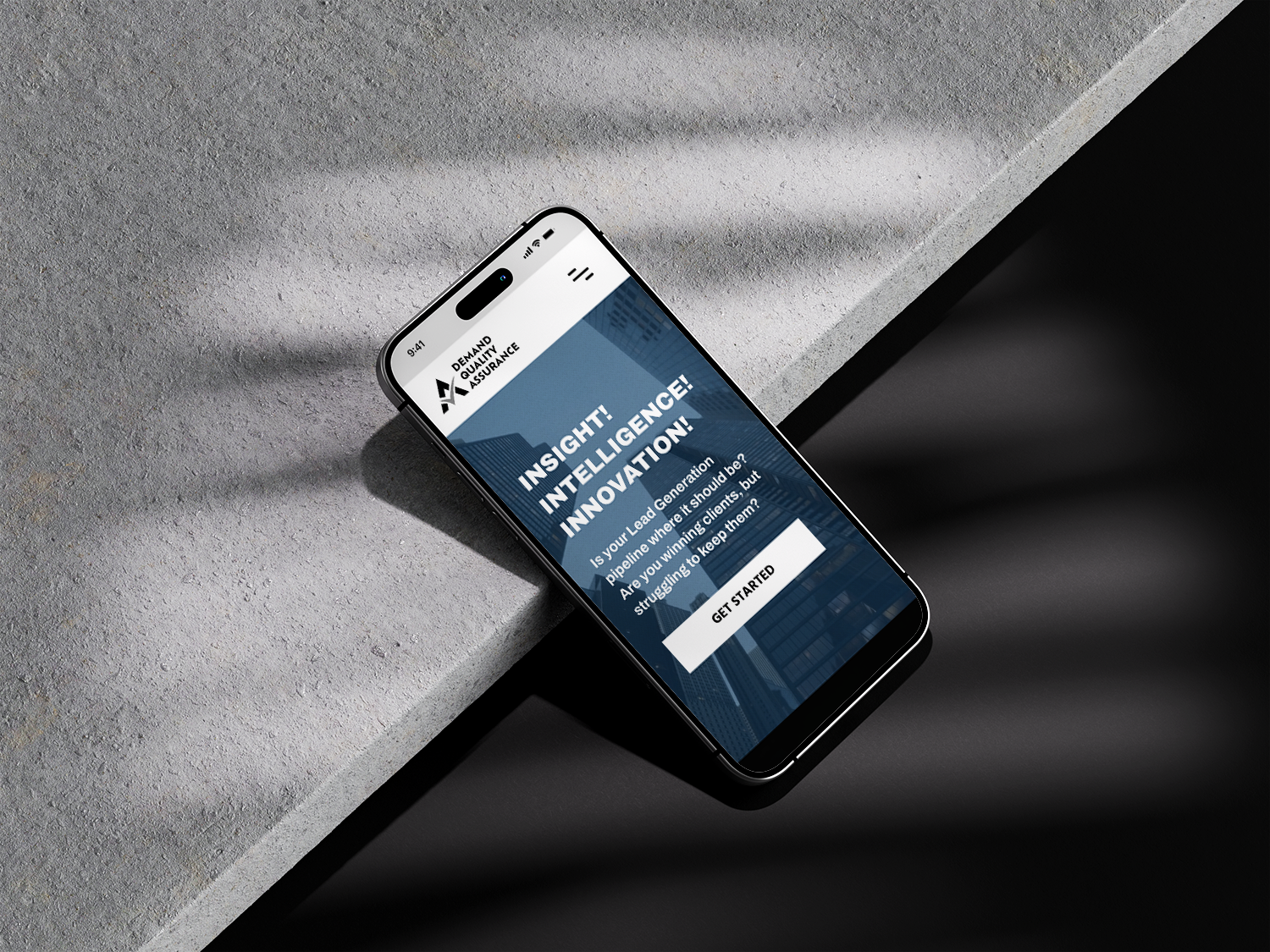Demand Quality Assurance Lead Generation Website on Phone Phone displaying the Demand Quality Assurance website design for a lead generation brand, designed by Dream Wild Studio