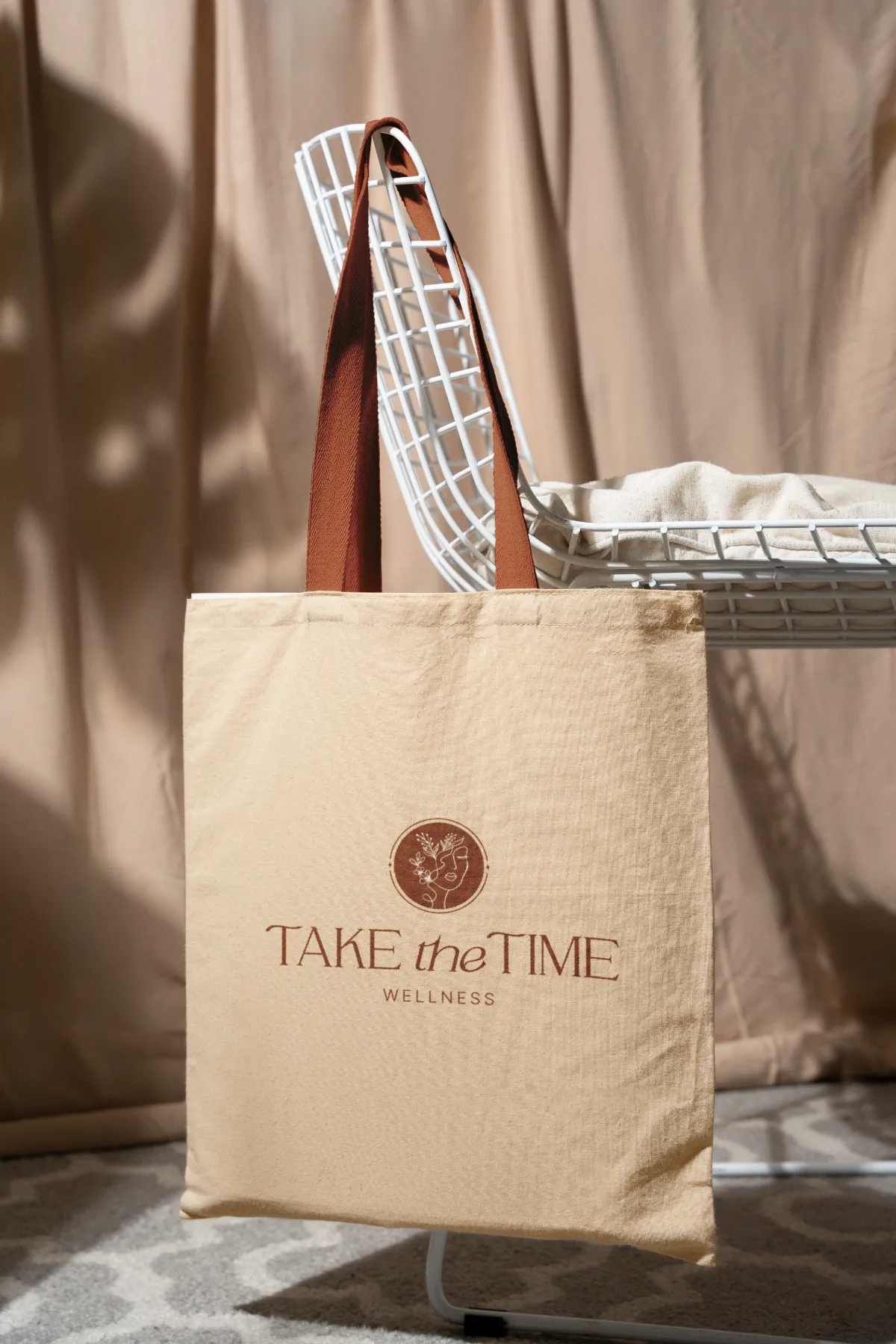 Take the Time Wellness logo on a tote bag for a holistic coaching company, branding by Dream Wild Studio