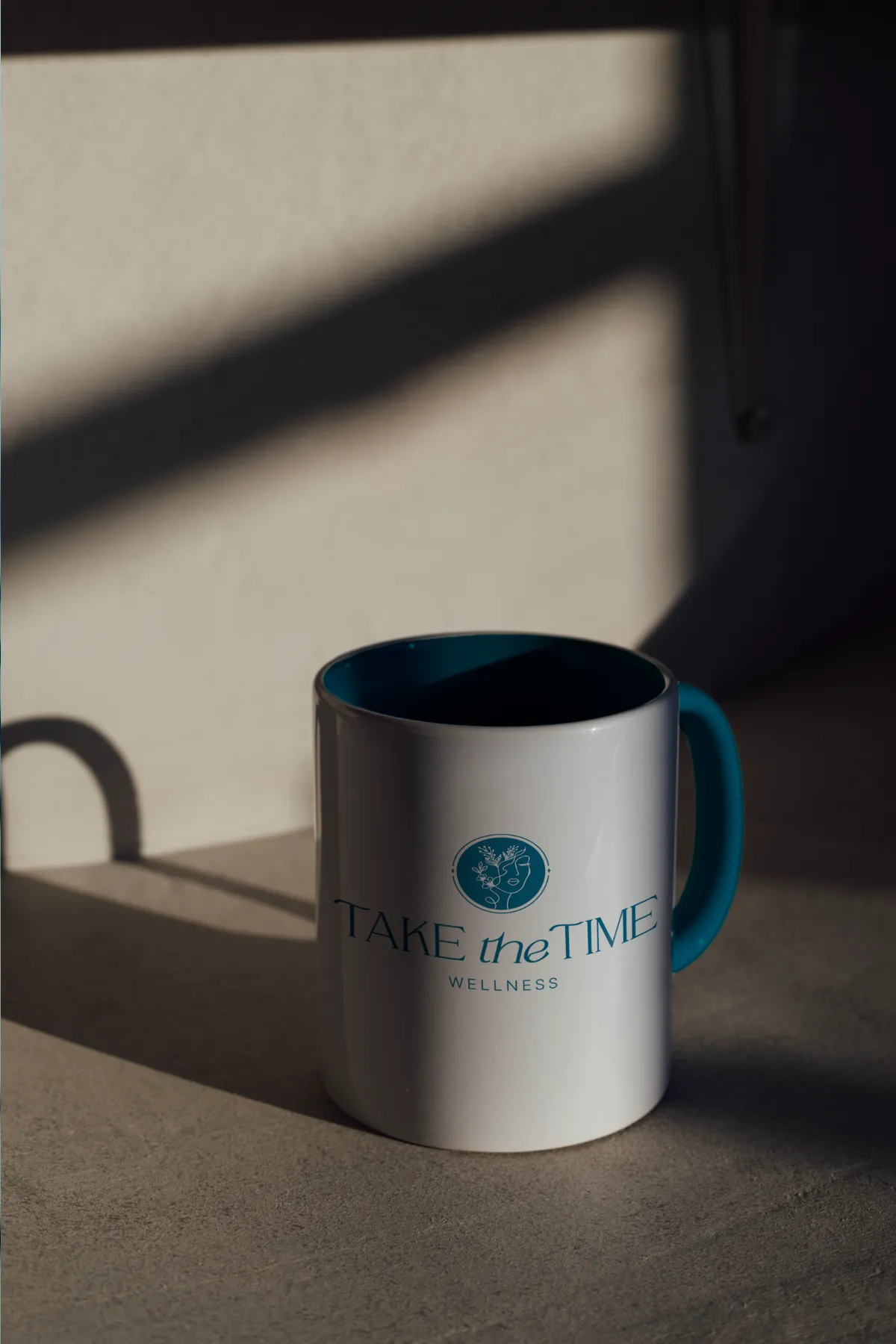 Take the Time Wellness logo on a mug for a holistic coaching company, branding by Dream Wild Studio