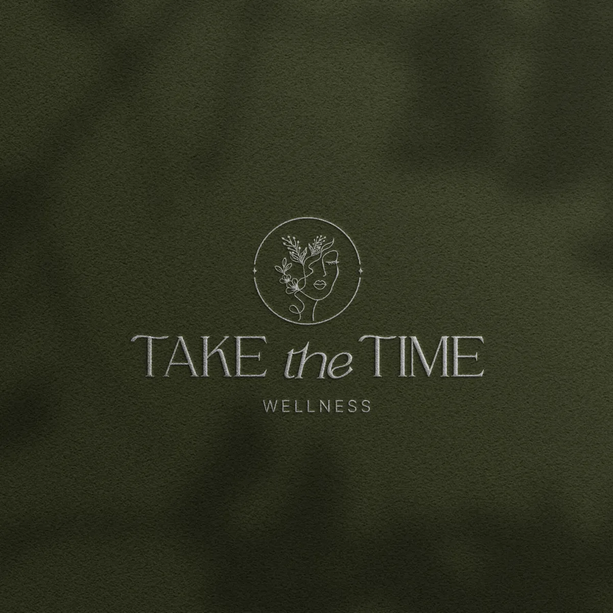 Take the Time Wellness logo on soft olive green fabric for a holistic coaching company, branding by Dream Wild Studio