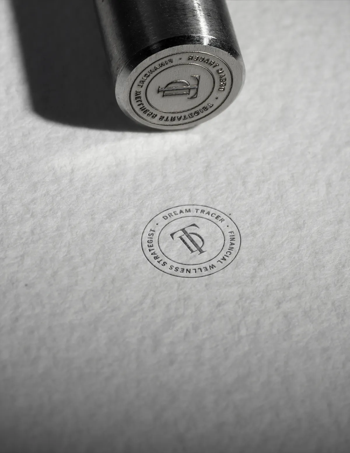 Embossed stamp featuring the Dream Tracer monogram logo for a financial strategist brand. Designed by Dream Wild Studio.