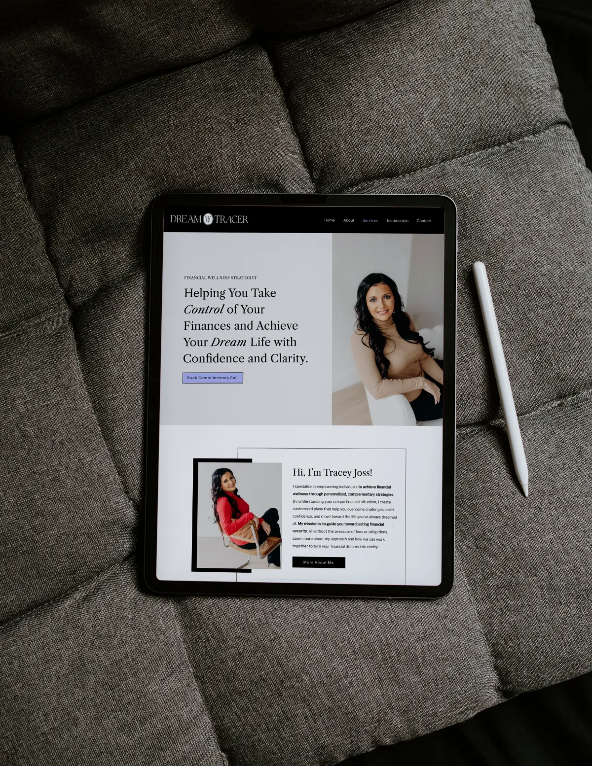 Tablet resting on a couch displaying the Dream Tracer website design for a financial strategist. Designed by Dream Wild Studio.