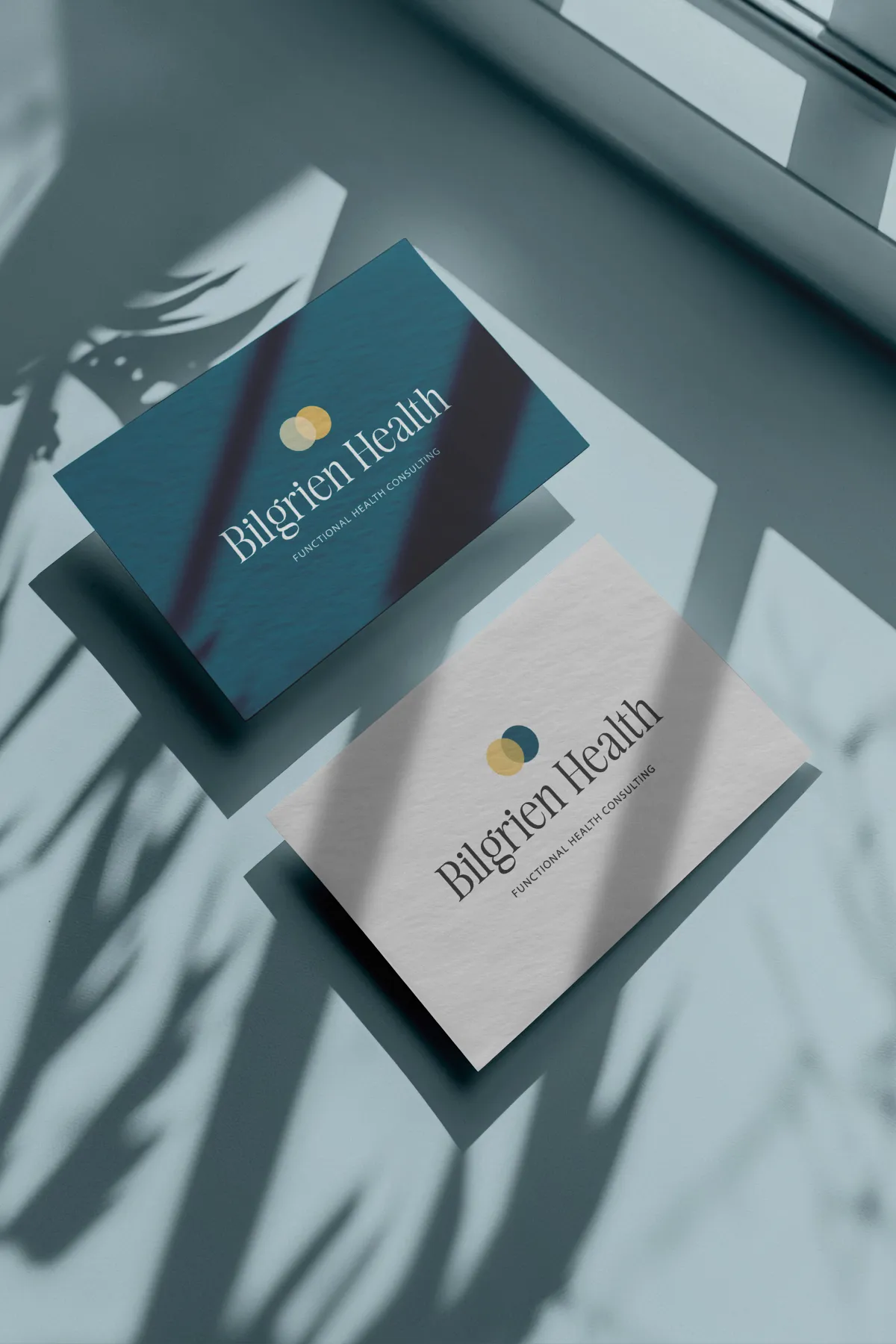 Bilgrien Health Business Card Design Deep teal business cards with the Bilgrien Health logo for a holistic health consultant, brand design by Dream Wild Studio