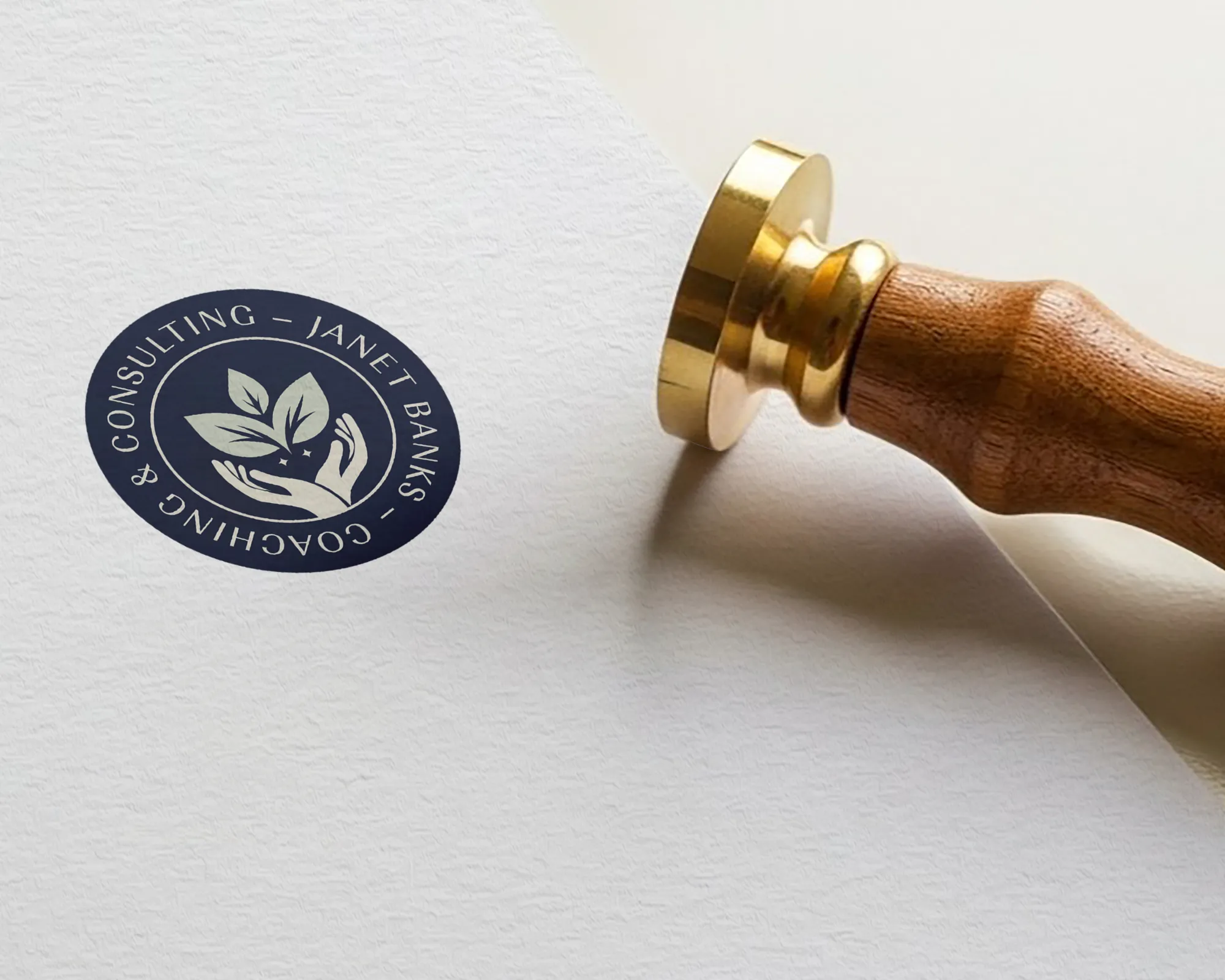 Wellness brand stamp with logo on paper for a nurse coach Janet Banks, by Dream Wild Studio.