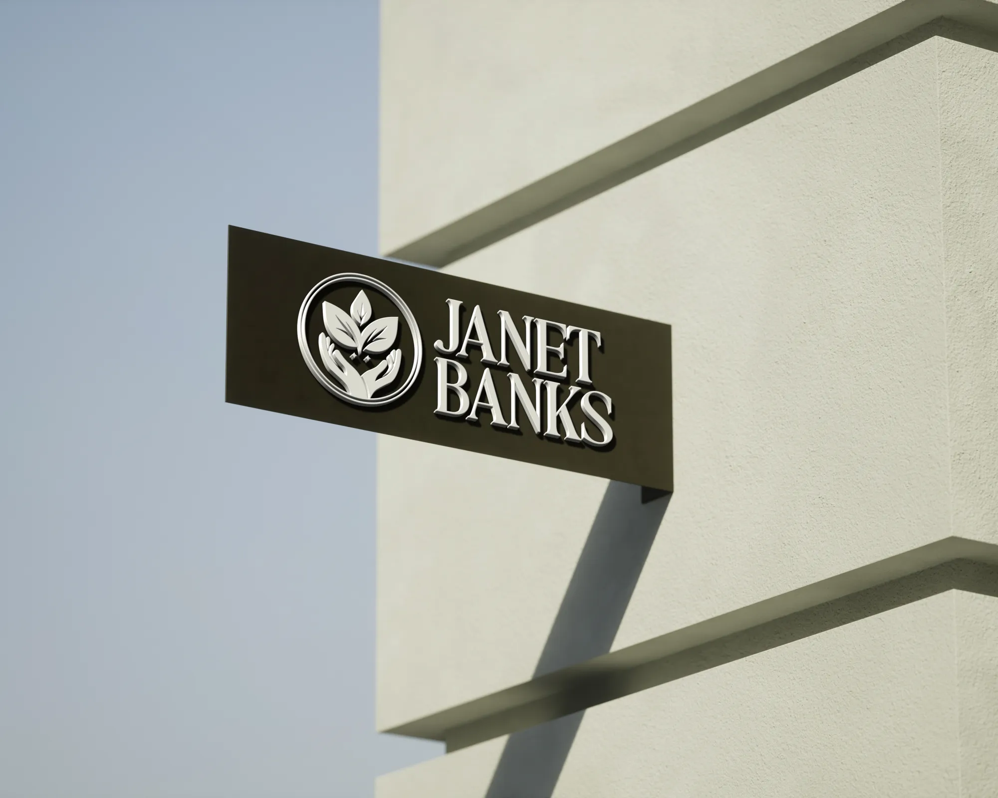 Wellness brand signage with logo design for Janet Banks mounted on building exterior, by Dream Wild Studio.