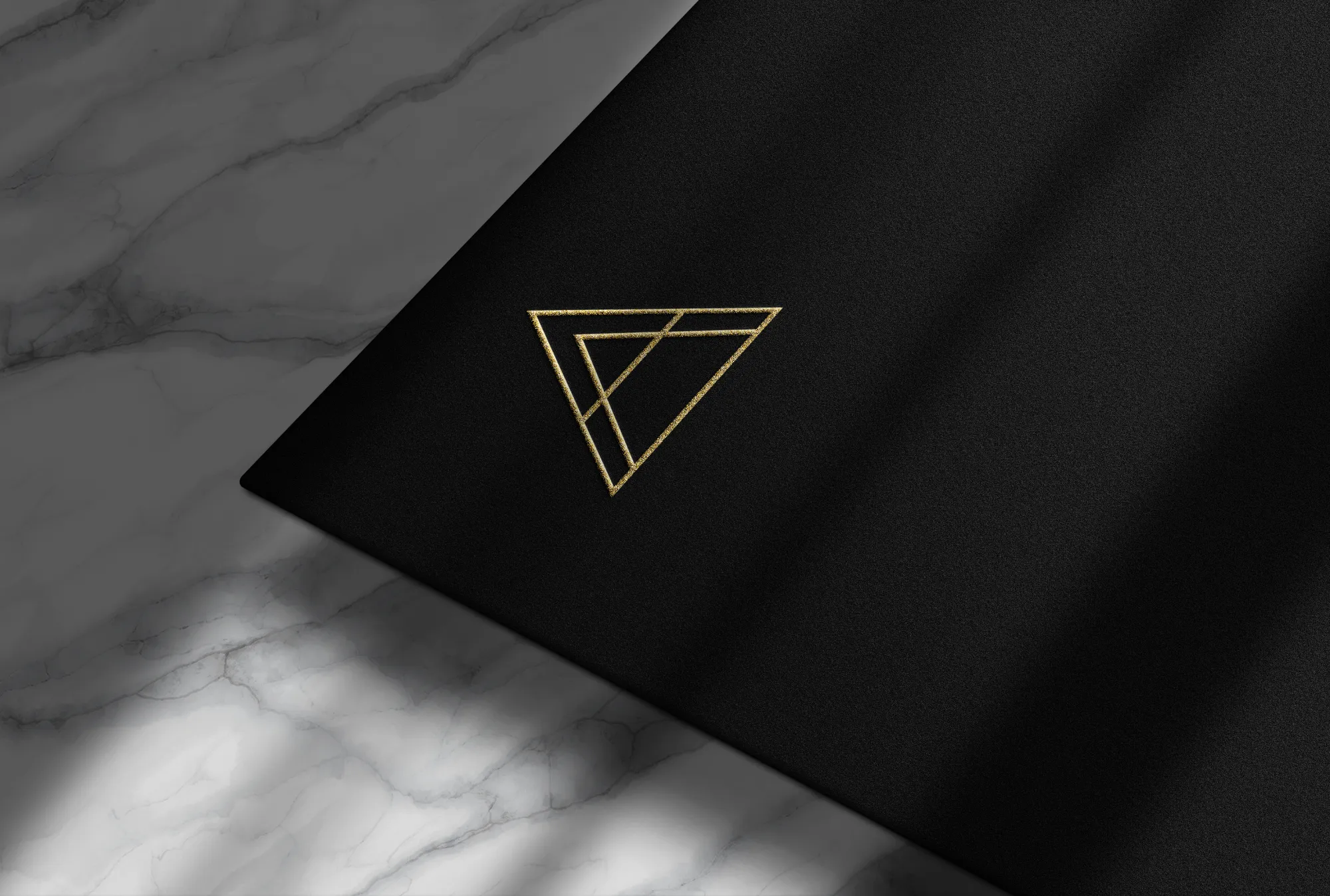 Minimal triangle logo for nurse coach brand The Coherence Studio in gold on dark background, by Dream Wild Studio.