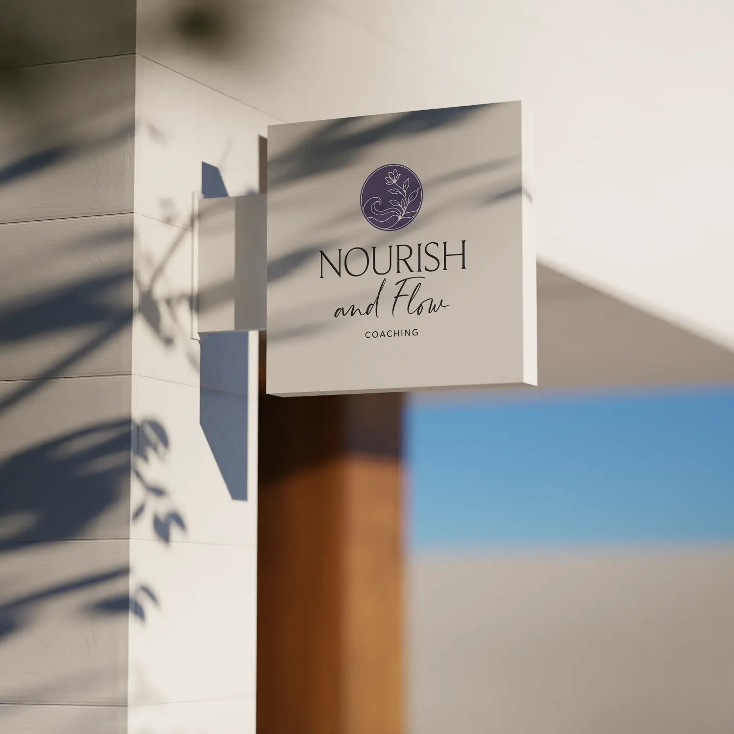 Nourish and Flow Coaching logo displayed on an exterior hanging sign for a holistic nurse coach brand, designed by Dream Wild Studio.