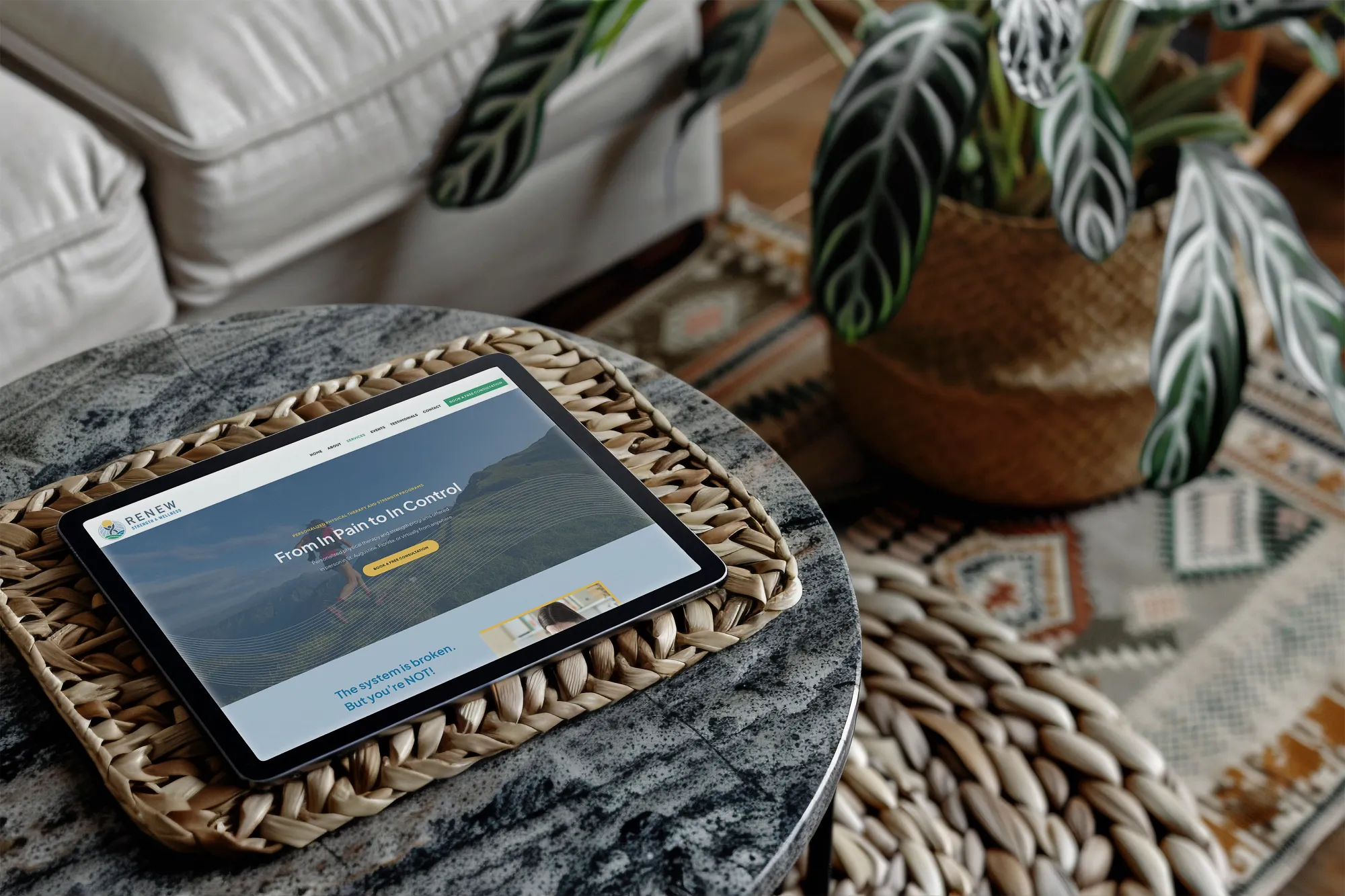 Custom wellness WordPress website displayed on a tablet in a warm, natural setting, designed by Dream Wild Studio.