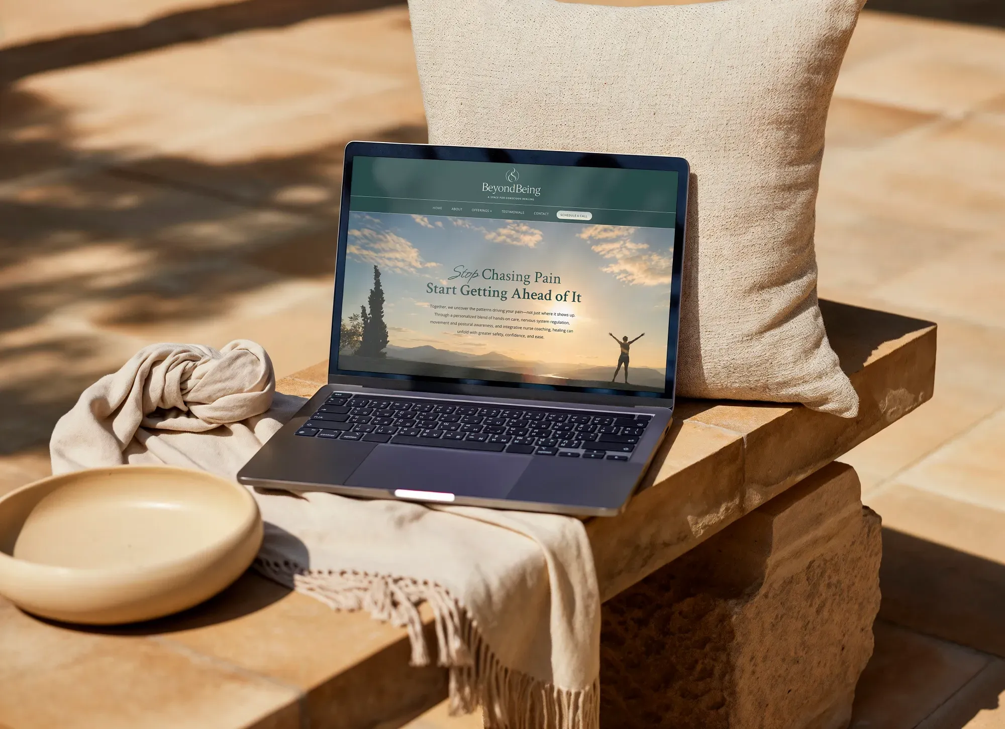 Integrative healing website displayed on a laptop in a warm interior setting by Dream Wild Studio
