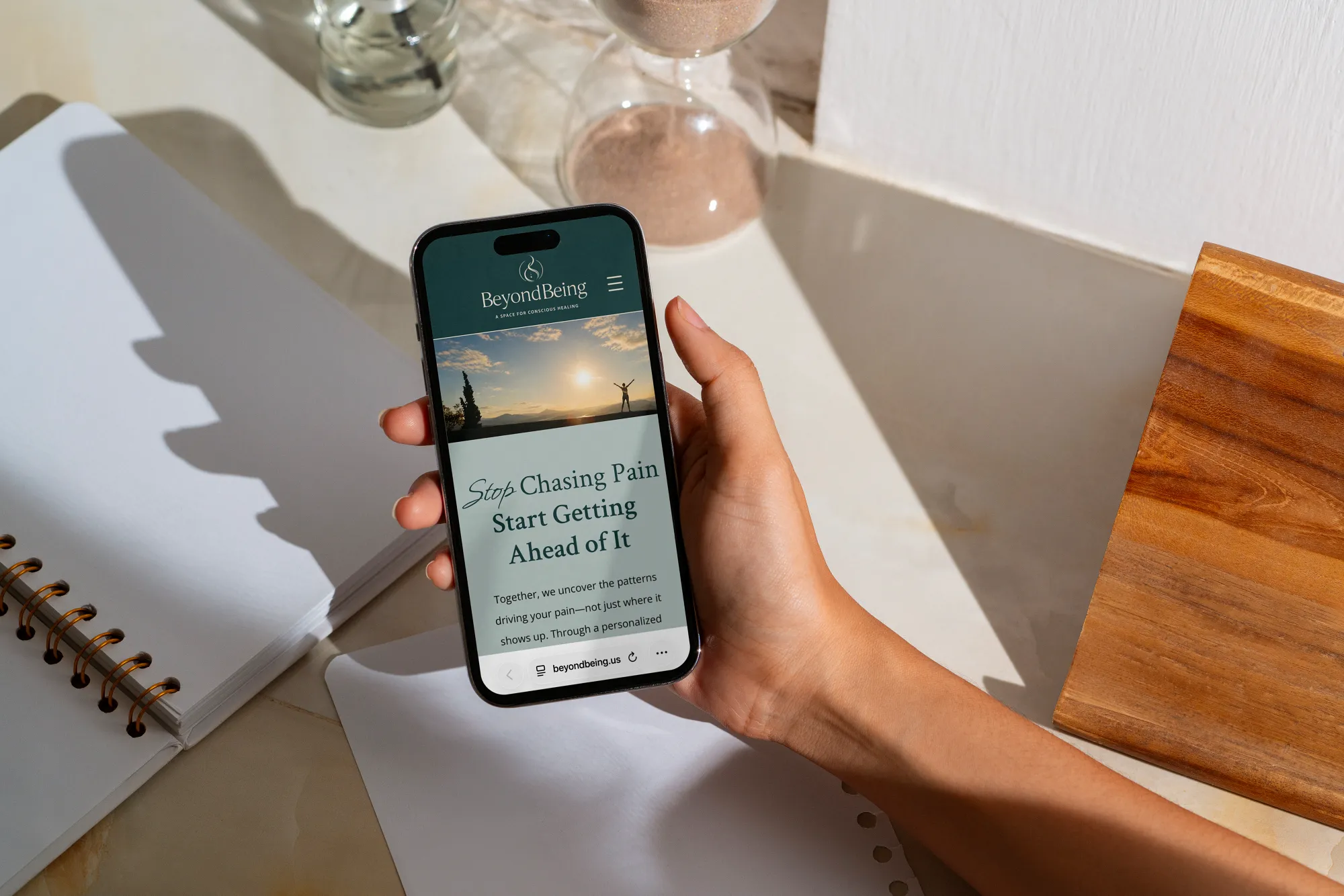 Mobile website design for an integrative healing practice displayed on a smartphone by Dream Wild Studio